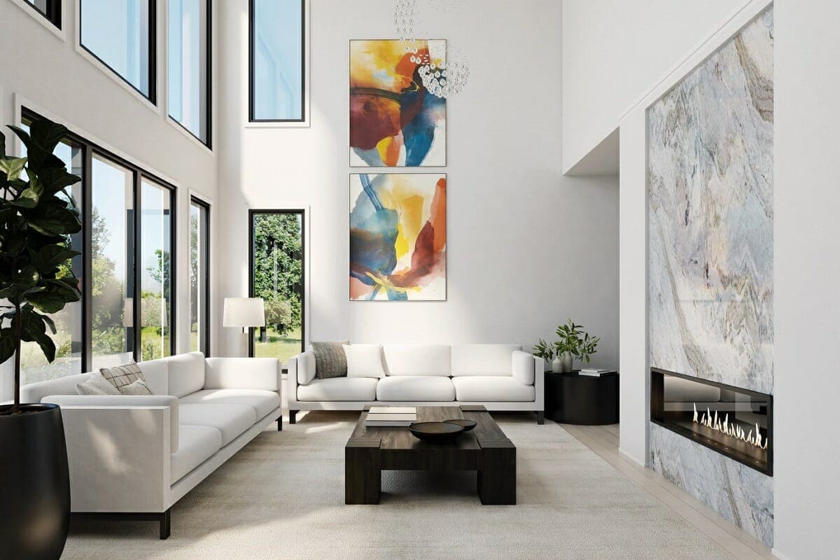 A minimalist living room with a simple white sofa, white walls, and a single coffee table