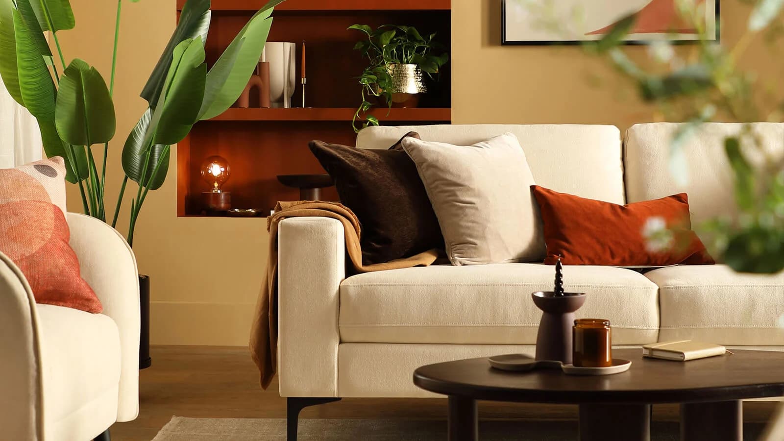 A warm living room with linen cushions, wooden furniture, and soft earthy tones