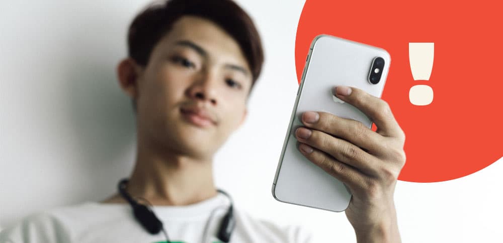 A person scrolling through rental listings on their phone with a suspicious look on their face