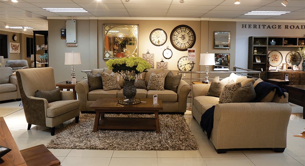A large and plush premium sofa set displayed in a well-lit showroom