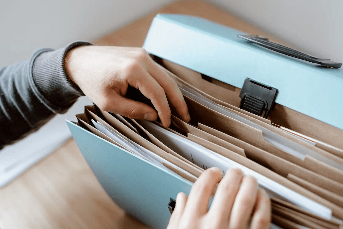 A person keeping a copy of an important rental agreement in a folder