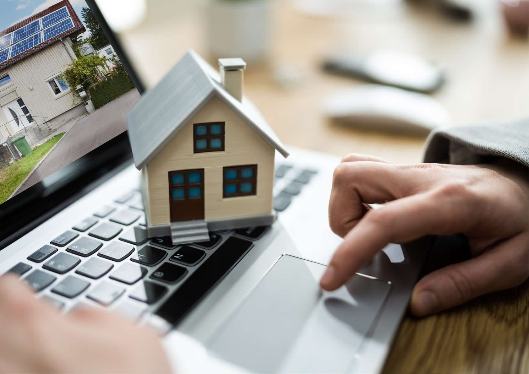 A person using a laptop to compare property prices on the RentNowBrunei website
