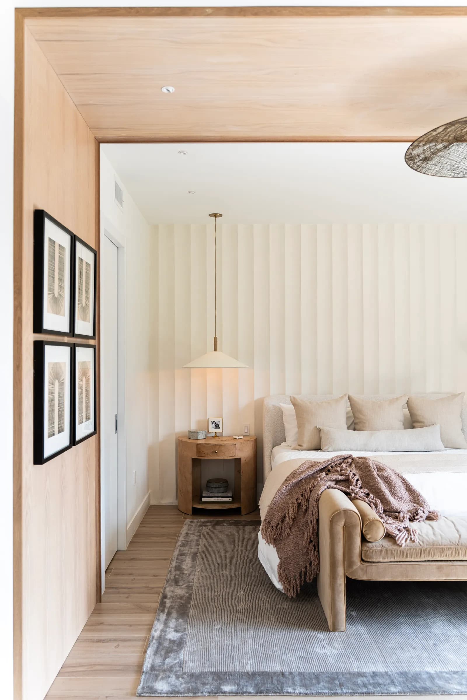 A modern room showing a clear gap of wooden flooring between the edge of the rug and the wall